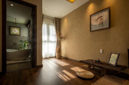 a bathroom with a tub and a bath tub at ZenHome by M2 in Hoi An