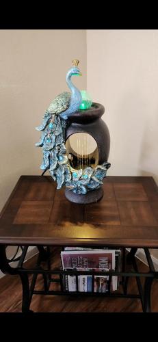 a peacock statue sitting on top of a table at Charming 1-bed apt, cook-ready kitchen, laundry, 5-8 mins to U of A and Downtown in Tucson