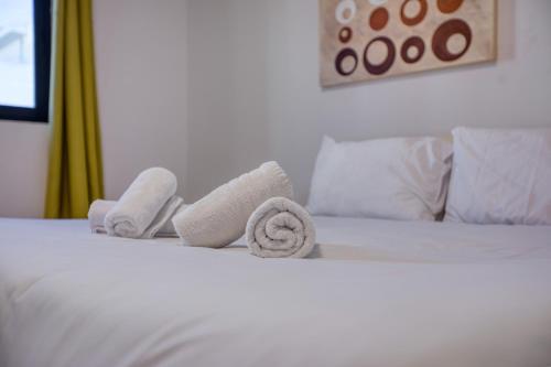 a hotel room with towels on a bed at Budget Friendly apartment in Central Swieqi - 10 minutes walk to Paceville & the beach in St. Julianʼs