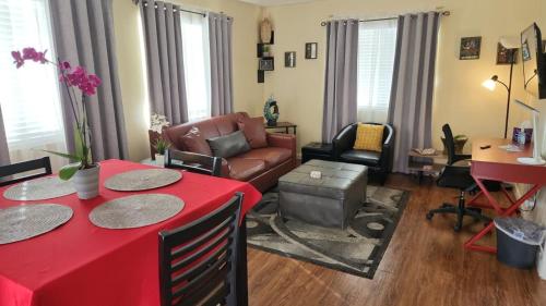 a living room with a red table and a couch at Charming 1-bed apt, cook-ready kitchen, laundry, 5-8 mins to U of A and Downtown in Tucson