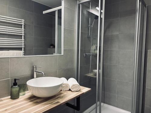 a bathroom with a sink and a shower at Levio Homes Sunny Alpine Apartments with Balconies in Haus im Ennstal