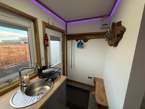 a bathroom with a sink and a window at Thurso Accommodation in Castletown