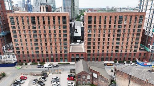 an aerial view of two large brick buildings in a city at Luxury 2bed flat around Manchester Victoria St in Manchester
