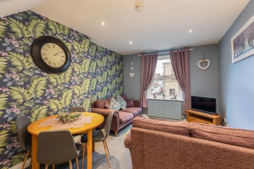 a living room with a clock on the wall at Pickering Town Apartment, Parking, Dog Friendly, in Pickering