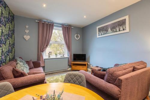 a living room with two couches and a table at Pickering Town Apartment, Parking, Dog Friendly, in Pickering