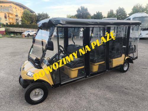 a yellow and black golf cart with a sign on it at BLASK LATARNl in Niechorze