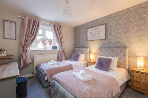 a bedroom with two beds and a window at Pickering Town Apartment, Parking, Dog Friendly, in Pickering