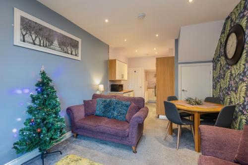 a living room with a christmas tree and a couch at Pickering Town Apartment, Parking, Dog Friendly, in Pickering