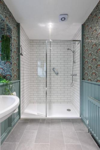 a shower with a glass door in a bathroom at Pickering Town Apartment, Parking, Dog Friendly, in Pickering