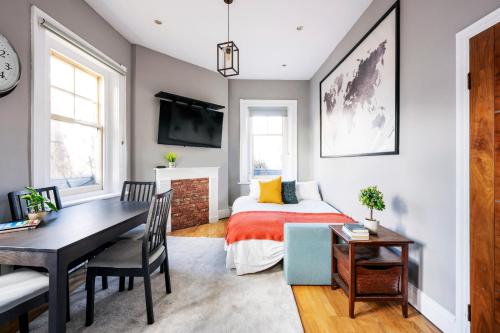 a bedroom with a bed and a desk and a table at Sunny Corner Apartment in Center of London in London
