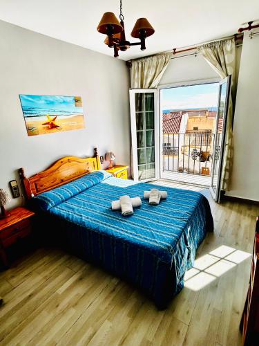 a bedroom with a large bed with towels on it at Hostal Cala Verde in Villaricos