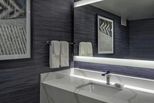 a bathroom with a white sink and a mirror at Albuquerque Marriott Pyramid North in Albuquerque