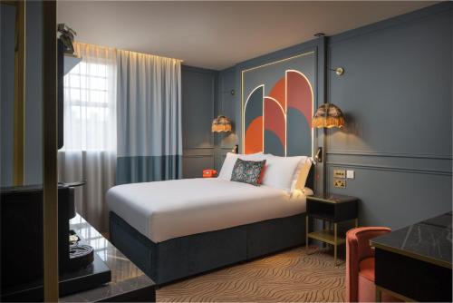 a hotel room with a bed and a large window at The Kensington Hideaway in London