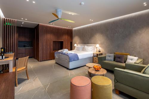 a hotel room with a bed and a living room at Selemnos Boutique in Patra