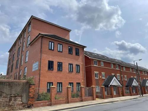 a brick building with a fence in front of it at Budget En-suites Optional Kitchen Liverpool in Liverpool