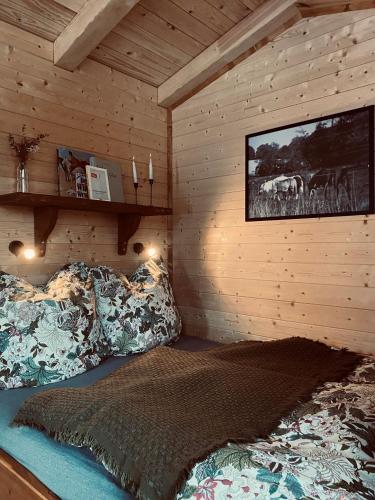 a bedroom with a bed and a tv on the wall at Tiny House Jovana in Kröpelin