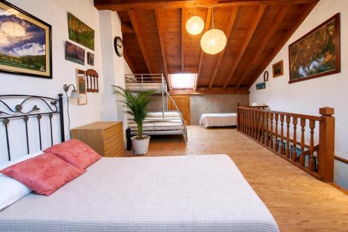 a bedroom with a bed and a wooden ceiling at Llanes casa cerca de la Playa de Poo – Ekilore in Po