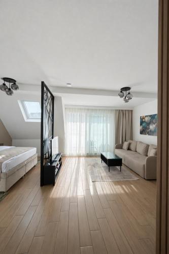 a large living room with a bed and a couch at Giorgio Luxury Suites in Belgrade