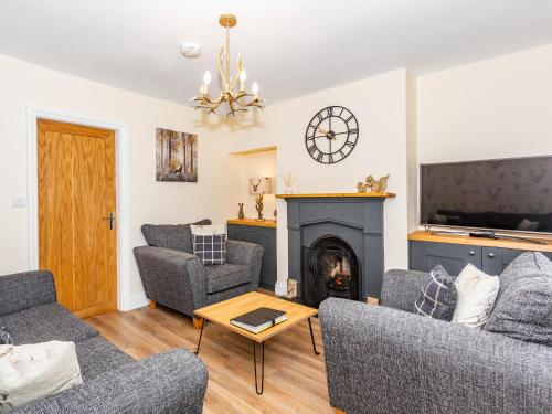 a living room with two couches and a fireplace at Court Terrace in Ripon