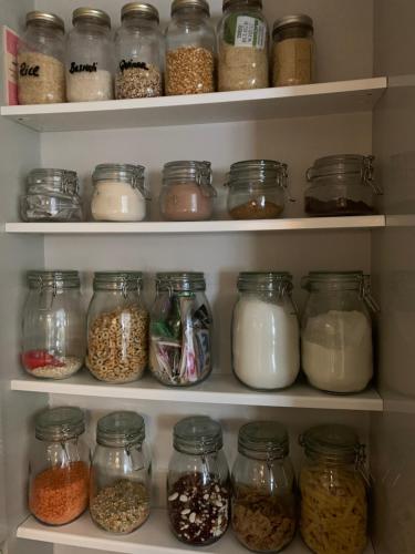 a refrigerator filled with lots of jars of food at Windsor Royal Retreat 2 bed 2 bath & private terrace in Windsor