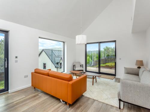 a living room with a couch and a table at Faodail in Portree