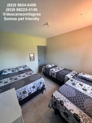 a hotel room with two beds in a room at Descanso Milagres in São Miguel dos Milagres