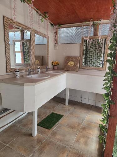 a bathroom with a white sink and a mirror at Andes Hostal Serena in La Serena
