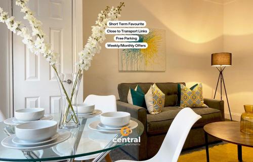a living room with a glass table and a couch at Lawson by CENTRAL SERVICED APARTMENTS - Cosy 1 Bedroom - Modern - Close to Transport Links - Quiet Neighbourhood - Fast WiFi - Fully Equipped - Smart TVs in All Rooms - Monthly Stays Welcome - FREE Street Parking - Ideal Relocation to Dundee Accommodation in Dundee