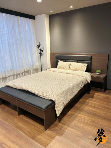 a bedroom with a large bed with a large window at Yume夢 堺店 in Sakai
