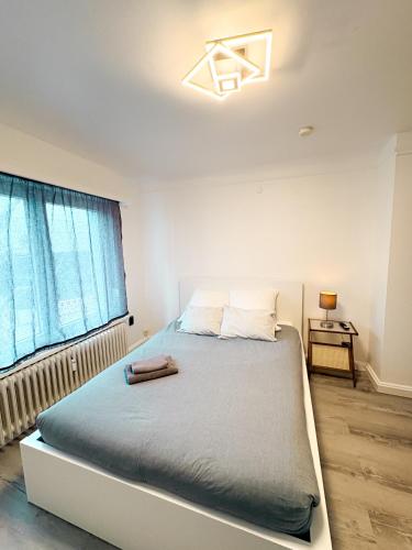 a bedroom with a bed and a window at Apartment Café Ettelbrück in Ettelbruck
