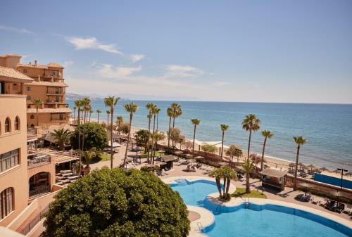 an aerial view of a resort with a swimming pool and the beach at Hotel IPV Palace & Spa - Adults Recommended in Fuengirola