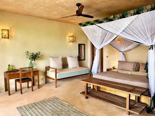 a bedroom with two beds and a ceiling fan at Afro Divers Lodge in Miperani
