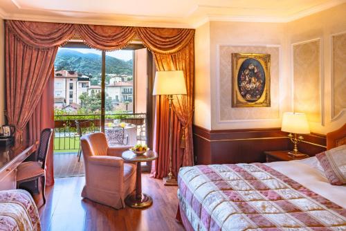 a hotel room with a bed and a large window at Grand Hotel Dino in Baveno