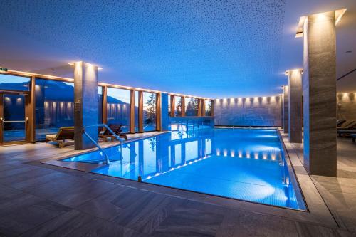 a swimming pool on the roof of a building at NIDUM - Casual Luxury Hotel in Seefeld in Tirol