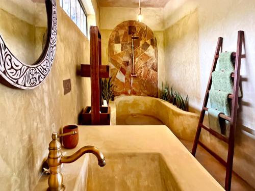 a bathroom with a sink and a mirror at Afro Divers Lodge in Miperani
