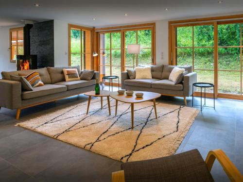 a living room with two couches and a table at Chalet Morris - OVO Network in Sixt
