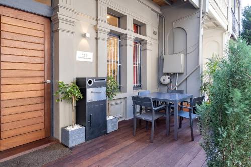 a porch with a table and chairs on a patio at Huge, Inner Sydney City 5 Bed Mansion, Near Opera House - 7 mins in Sydney