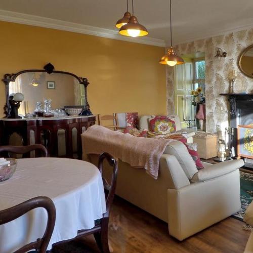 a living room with a couch and a table at Shannonview Country House in Labasheeda