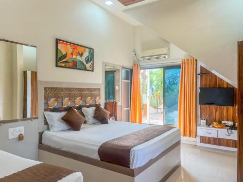 a bedroom with a bed and a large window at Green Paradise - Trimbakeshwar in Trimbak