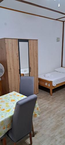 a room with two beds and a table and a chair at Apartments Stanko in Sumartin