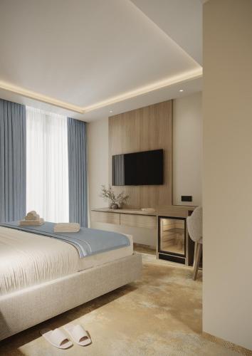 En eller flere senge i et værelse på Hotel Diana