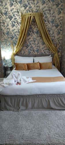 a bed with two stuffed animals sitting on it at The Celtic Pride Hotel in Blackpool