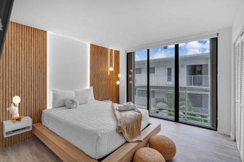 a bedroom with a bed and a large window at Waterfront 3bed | Pool | 10min walk to Beach in Hallandale Beach