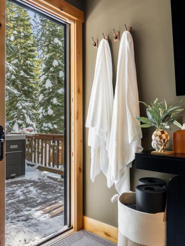 a room with a sliding glass door with towels at Starlight Chalet Lake Tahoe in Carnelian Bay