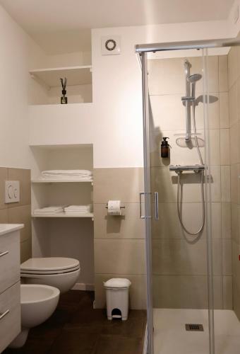 a bathroom with a shower and a toilet at Piazza del Lago Suites - Menaggio in Menaggio