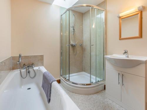 a bathroom with a shower and a tub and a sink at 1 Bed in Helston oc-bbird in Saint Martin