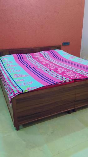 a bed with a wooden frame in a room at Sahib ka Ghar in Kharar