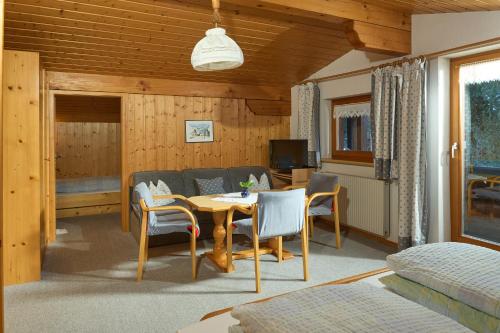 a living room with a table and chairs and a couch at Haus Muster - Hochmontafon in Partenen