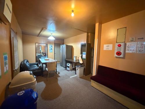 a small room with a desk and a table in a room at 駅本ビル民宿4階 in Yuzawa