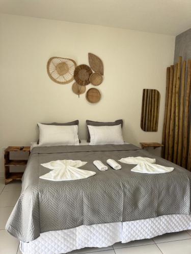 a bedroom with a bed with two slippers on it at Pousada Flor De Prado in Prado